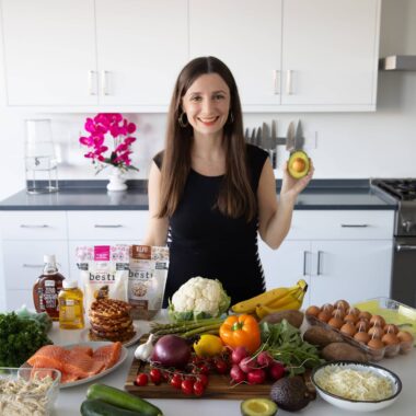 Maya Krampf with fresh produce holding an avocado.