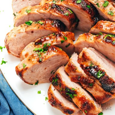 Air fryer pork tenderloin sliced on a plate.
