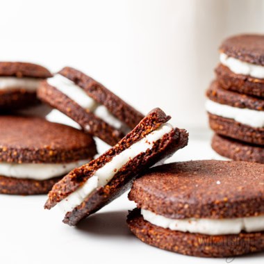 Healthy oreos in a pile on white counter.