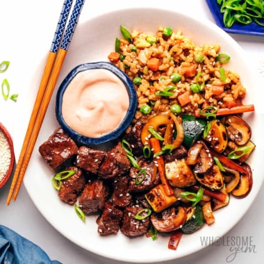Hibachi steak on a plate with rice and veggies.